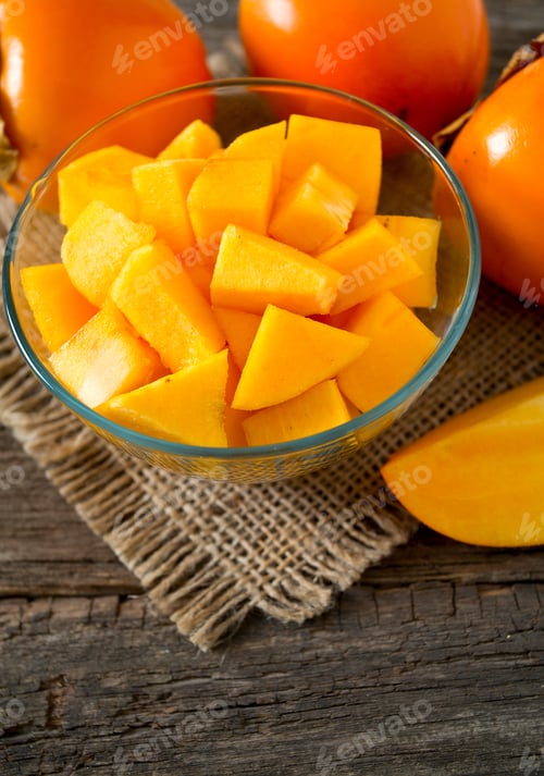 Preview: Cut Persimmon On Wooden Surface