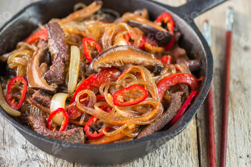 Preview: Glass Noodles With Beef, Mushrooms And Vegetables In A Cast Iron Skillet. Dish Of Korean Cuisine