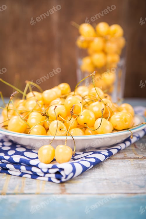 Preview: Fresh Ripe Raw Yellow Sweet Cherry On Colored Plate