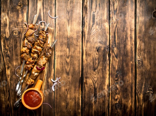 Preview: Kebab With Tomato Sauce. On Wooden Background.