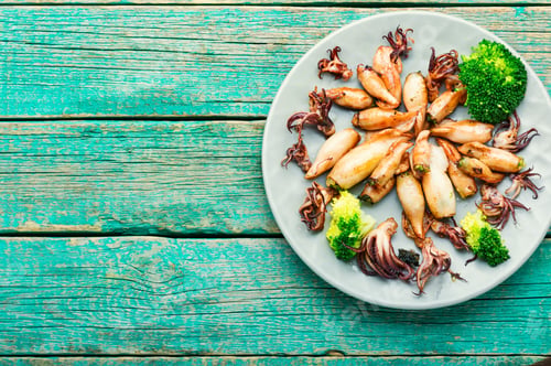 Preview: Baked Squid Stuffed With Broccoli,Mushrooms On Retro Wooden Table.Appetizing Seafood.Copy Space