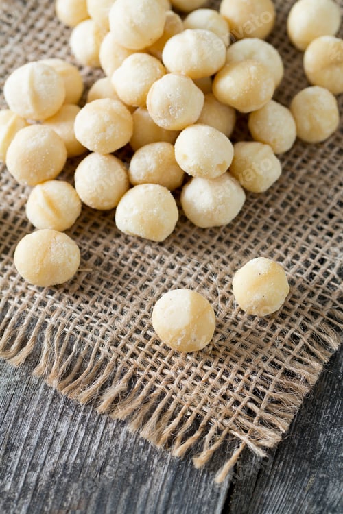 Preview: Salted Macadamia Nuts On Wooden Surface