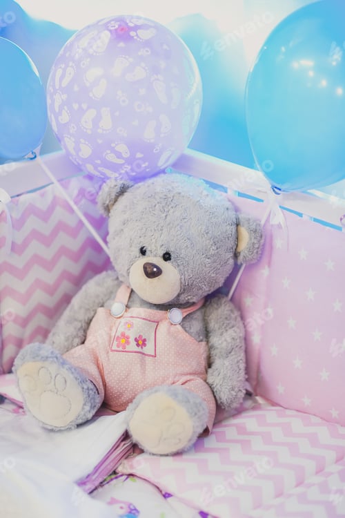 Preview: Toy Bear Sitting In The Cot In Pink Shades Of Blue Colors. Happy Toy For Newborn Kids Or Babies