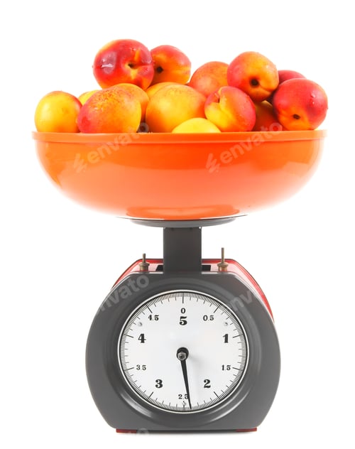 Preview: Apricots On Scales On A White Background.