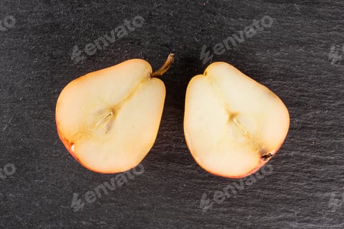 Preview: Group Of Two Halves Of Fresh Red Pear Flatlay On Grey Stone