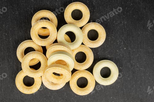 Preview: Lot Of Whole Round Pale Yellow Candy Flatlay On Grey Stone