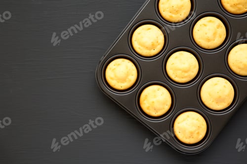Preview: Homemade Cornbread Muffins On A Black Surface, Top View. Flat Lay, Overhead, From Above. Copy Space.