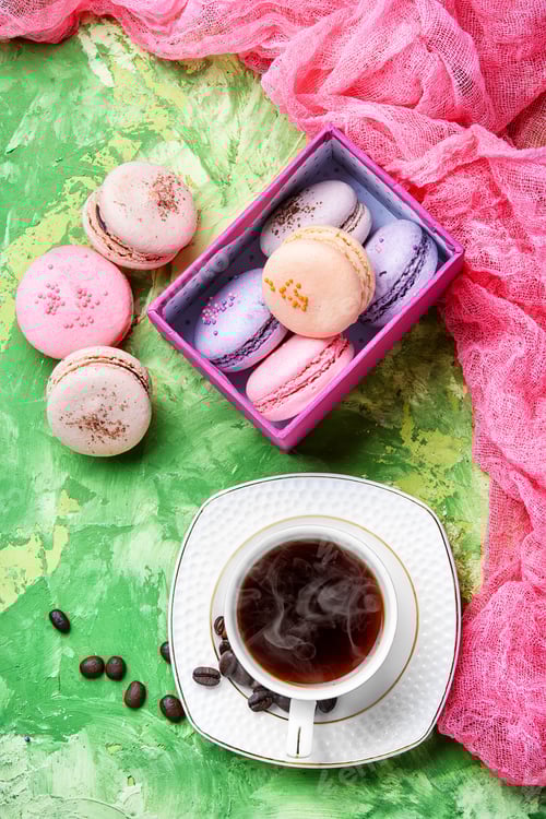 Preview: Coffee And Colorful French Macaroons On Green Background
