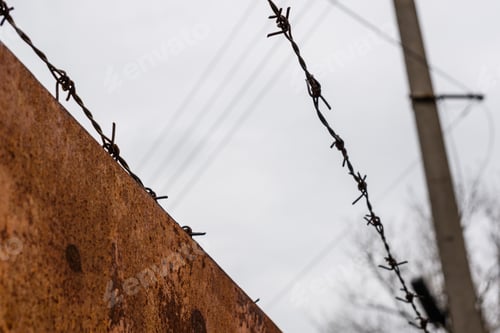 Preview: Barbed Wire Against Sky On Cloudy Day