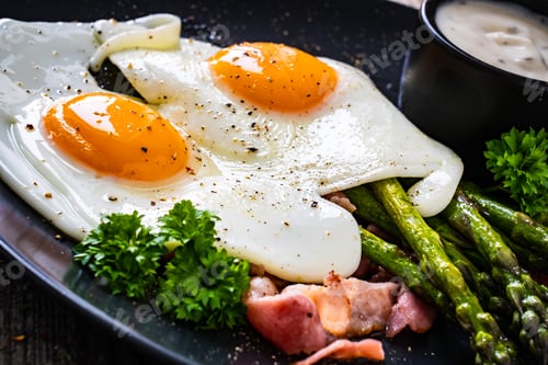 Preview: Tasty Breakfast. Sunny Side Up Eggs With Green Asparagus, Fried Bacon And Garlic Dip Served On
