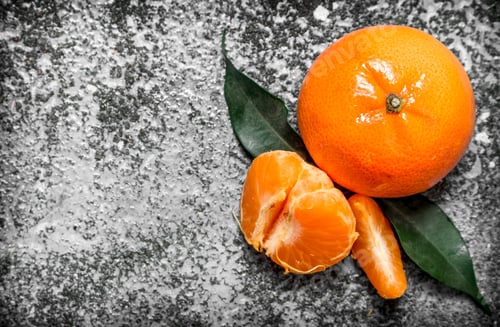 Preview: Ripe Tangerines With Green Leaves. On Rustic Background.
