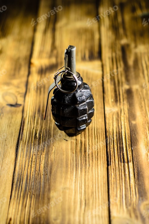 Preview: Black Hand Grenade On The Wooden Table