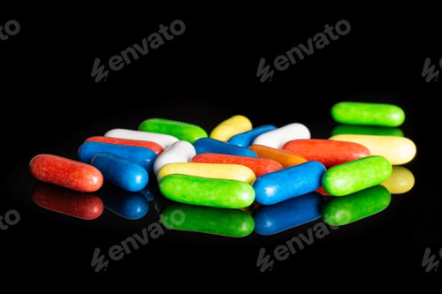 Preview: Lot Of Whole Sweet Licorice Comfit Isolated On Black Glass