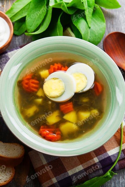 Preview: Sorrel Soup With Egg On Wooden Table