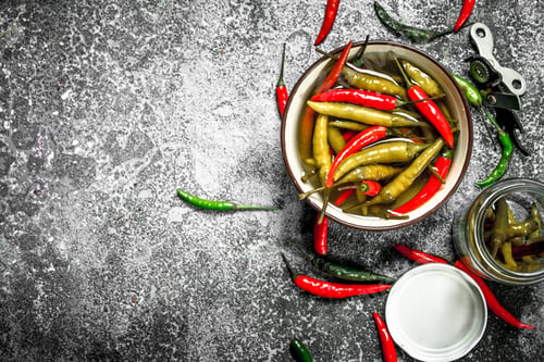 Preview: Pickled Chili Peppers In A Bowl. On A Rustic Background.