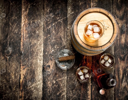 Preview: Whiskey Background. A Barrel Of Scotch Whiskey With Glass And A Cigar. On A Wooden Background.