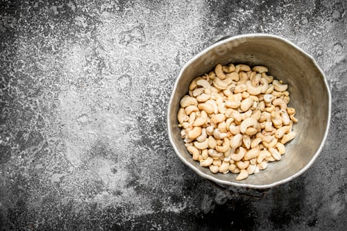 Preview: Cashews In The Old Bucket. On Rustic Background.