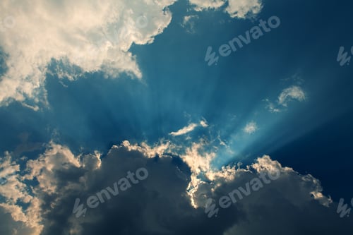 Preview: Sun Rays Through Clouds in Blue Sky