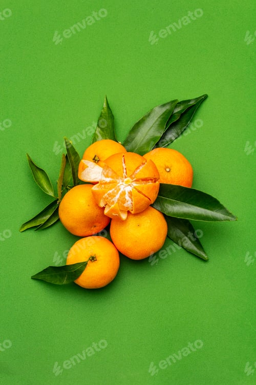Preview: Ripe Tangerines With Leaves. Fresh Fruits Isolated On Green Background, Copy Space, Top View