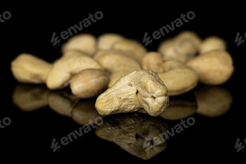 Preview: Lot Of Whole Brown Nut Cashew Heap Isolated On Black Glass