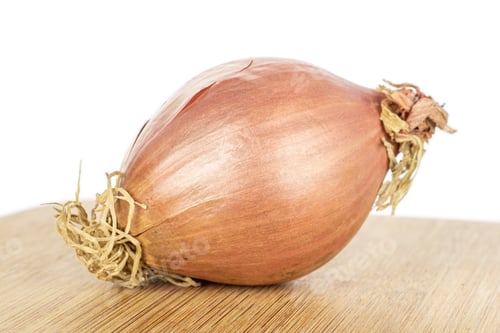 Preview: One Whole Fresh Brown Shallot On Bamboo Cutting Board Isolated On White Background