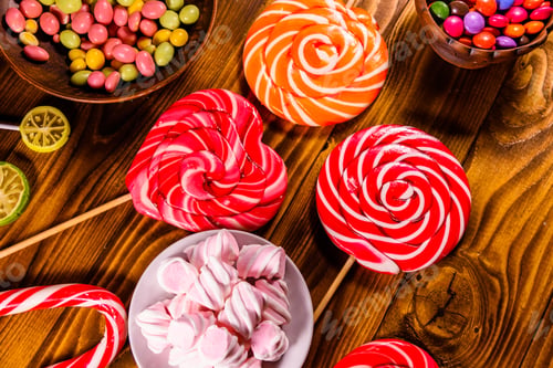 Preview: Ceramic Plate With Marshmallow, Candy Cane And Lollipops On Rustic Wooden Table. Top View