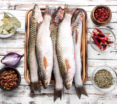 Preview: Fresh Raw Fish On Wooden Cutting Board.Raw Fish With Spices For Cooking.Seafood