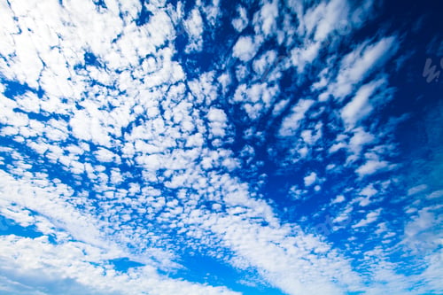 Fluffy White Clouds Against a Vivid Blue Sky