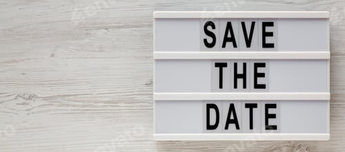Preview: 'Save The Date' Words On A Modern Board On A White Wooden Background, Top View. Overhead, From