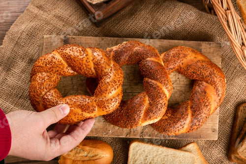 Preview: Man Taking Tasty Bagel From Kitchen Board