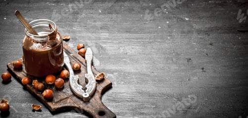 Preview: Chocolate Butter With Hazelnuts. On A Black Chalkboard.