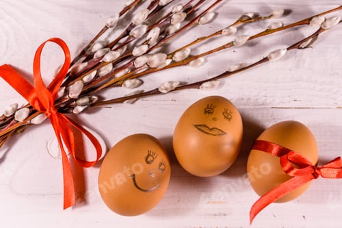 Preview: Pussywillow Bouquet And Easter Eggs On White Wooden Table. Top View