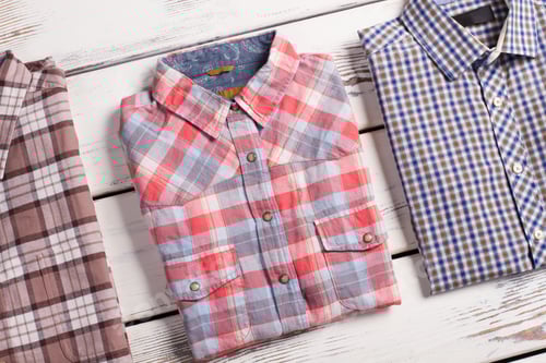 Preview: Three Plaid Shirts Neatly Folded on White Surface