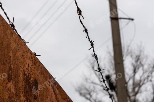 Preview: Barbed Wire Against Sky On Cloudy Day