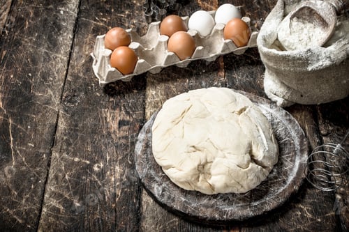 Preview: Fresh Dough With Ingredients. On A Wooden Background.