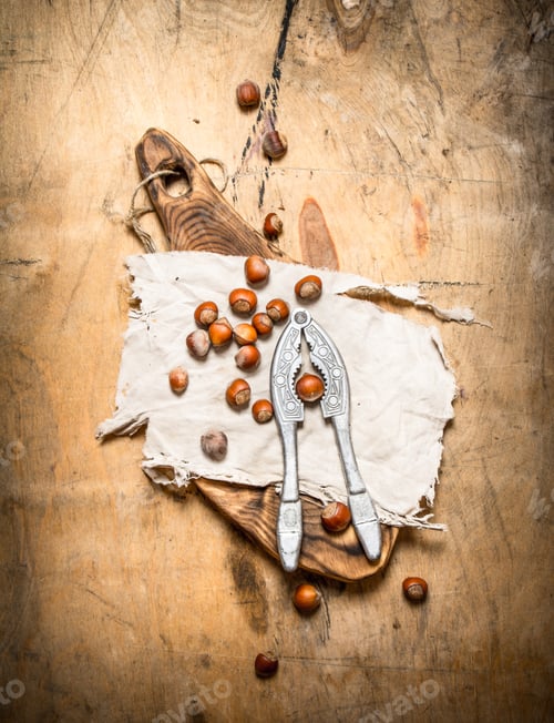Preview: Nuts With Nutcracker And Shell. On A Wooden Table.