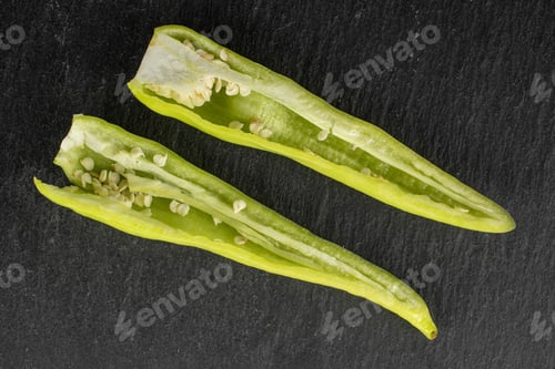 Preview: Group Of Two Halves Of Hot Green Pepper Banana Flatlay On Grey Stone