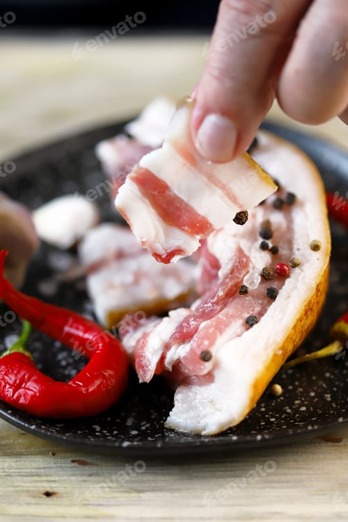 Preview: Selective Focus. A Piece Of Bacon In Hand. Fresh Lard.