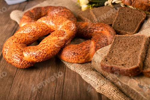 Preview: Bagel And Slices Of Dark Bread On Tablecloth
