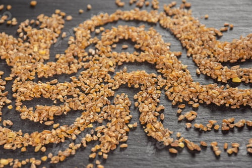 Preview: Lot Of Whole Raw Bulgur Grains Waving On Grey Stone
