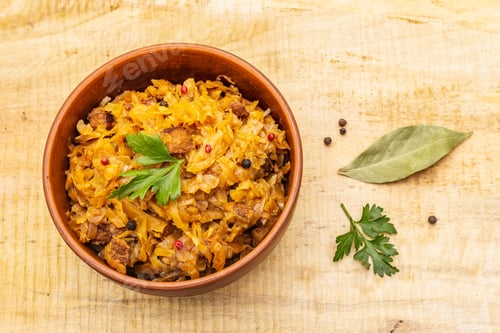 Preview: Stewed (Braised) Cabbage Served On Ethnic Ceramic Bowl. Traditional Polish Bigos With Meat