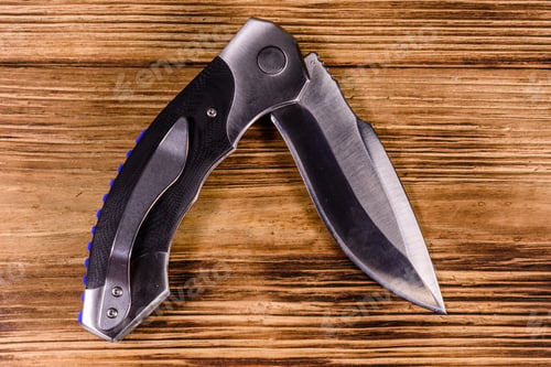 Preview: Opened Folding Knife On Rustic Wooden Table. Top View