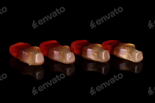 Preview: Group Of Four Whole Sweet Jelly Cola Isolated On Black Glass