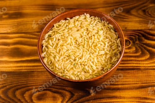 Preview: Ceramic Bowl With Prepared Instant Noodles On Rustic Wooden Table