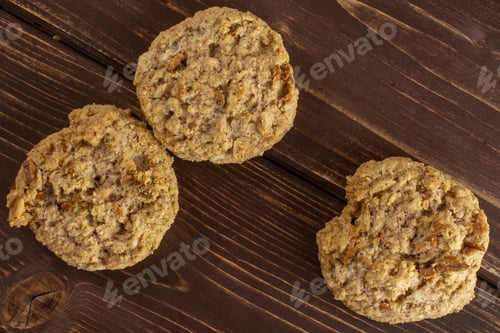 Preview: Group Of Three Whole Oat Crumble Biscuit Flatlay On Brown Wood