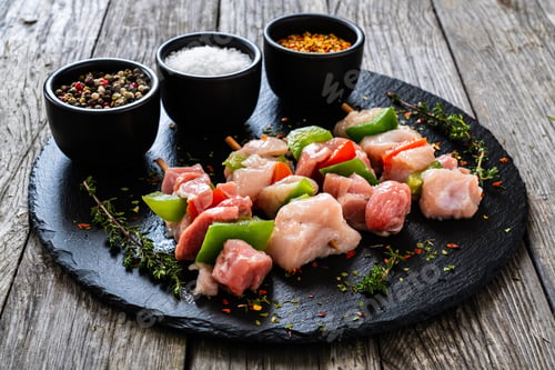 Preview: Uncooked Shashlik And Seasonings On Black Stone Board On Wooden Table