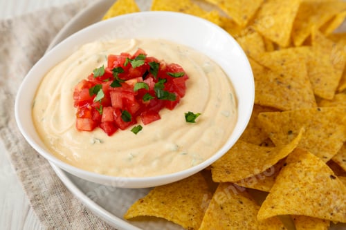 Preview: Homemade Cheesy Dip In A Bowl, Yellow Tortilla Chips, Side View. Close-Up.
