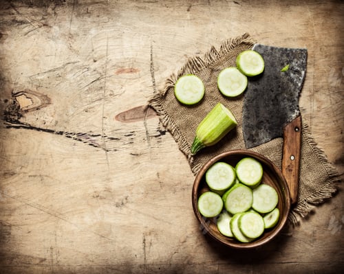 Preview: Sliced Zucchini And An Old Hatchet . On Wooden Background.