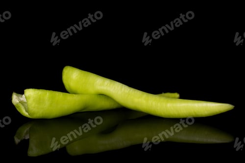 Preview: Group Of Two Halves Of Hot Green Pepper Banana Isolated On Black Glass