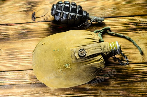 Preview: Army Flask In Rag Khaki Cover And Hand Grenade On Wooden Table